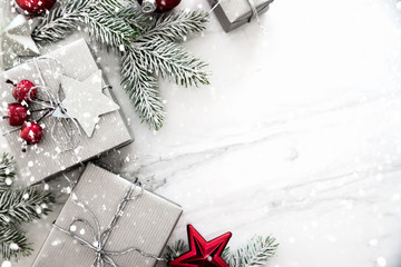 Christmas and New Year holiday background. Xmas greeting card. Christmas gifts on white marble background top view. Flat lay