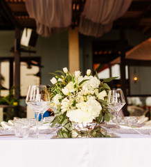 Set table for a white and aqua blue wedding dinner decorated