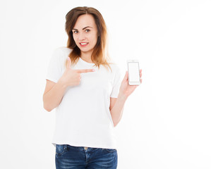 Portrait of smile, sexy woman in t shirt showing blank screen of her smartphone isolated on white background. Copy space