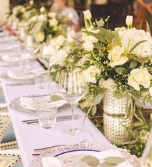 Set table for a white and aqua blue wedding dinner decorated