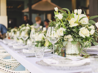 Set table for a white and aqua blue wedding dinner decorated