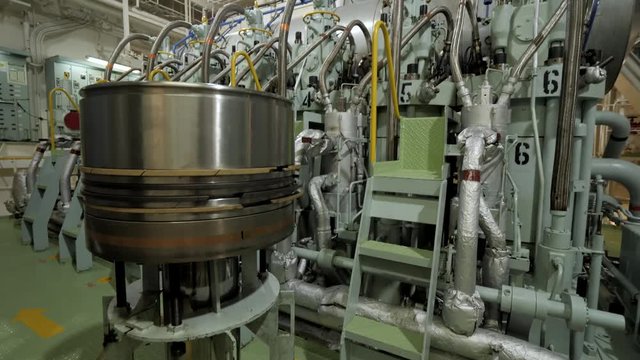 New piston near marine diesel in engine room of ship