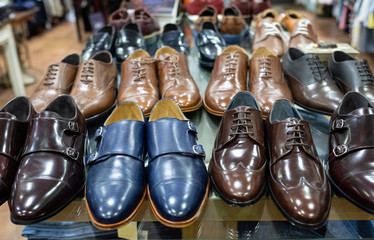 shelf of pairs of blue and brown shoes