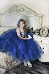 Young princess in a blue evening dress