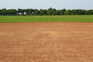 A view of the dirt infield and the pitchers mound at the field.