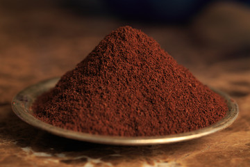 ground coffee on bowl on a marble background