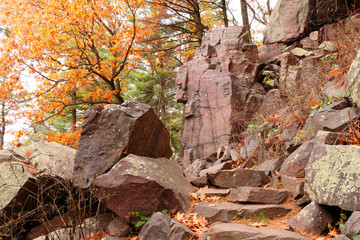 Wisconsin ice age nature background. Autumn view with ice age hiking trail with colorful trees and stone stairs between rocks. Devils Lake State Park, Baraboo area, Wisconsin, USA.