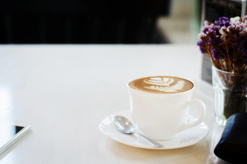 Coffee cup on white table background selective focus soft tone with copy space.