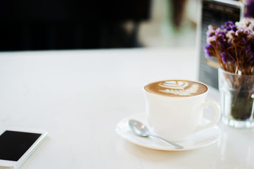 Coffee cup on white table background selective focus soft tone with copy space.