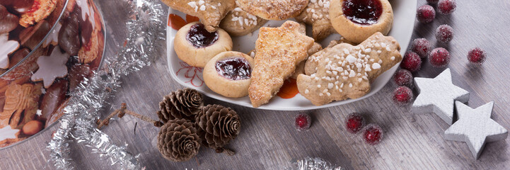 Christmas cookies with decoration on wooden table. Panorama