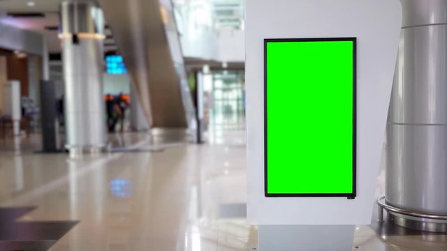 Empty billboard with green screen background in the airport terminal. Shot in 4k resolution