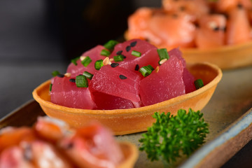 Chopped raw salmon, tuna and octopus canapes