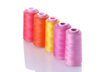 Multicolored spools with threads on white isolated background. accessories for sewing