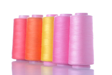 Multicolored spools with threads on white isolated background. accessories for sewing