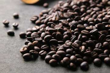 Roasted coffee beans close-up. mixture of arabica and robusta on a black background