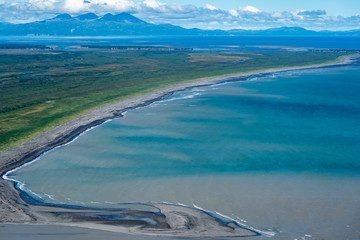 Aerial photography view of Alaska's Katmai National Park. Teal water, lush green mountain vegetation and sandbars into the Cook Inlet © MelissaMN