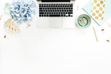 Home office desk workspace with laptop, hydrangea flowers bouquet, accessories on white background. Flat lay, top view decorated mockup.