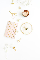 Female gold styled workspace with notebook, scissors and clips on white background. Flat lay, top view.