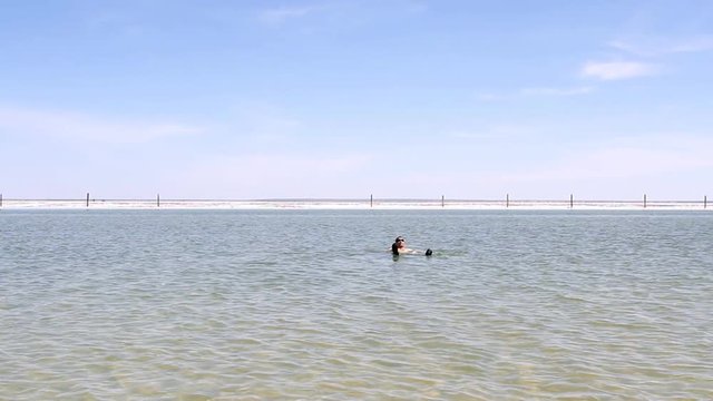 Man swimming in the lake.
