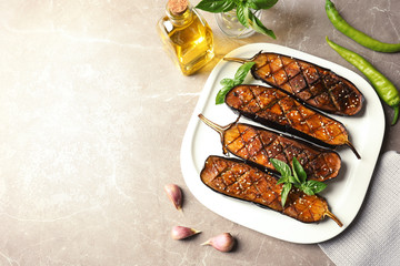 Plate with fried eggplant slices on table, top view. Space for text
