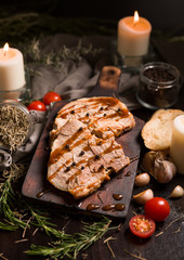 Grilled T-bone steak on cutting board