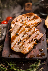 Grilled T-bone steak on cutting board