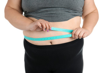 Overweight woman with measuring tape on white background, closeup