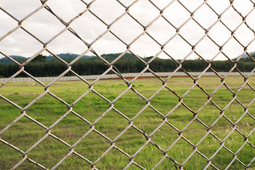 wire mesh steel with green grass background in Phuket Thailand