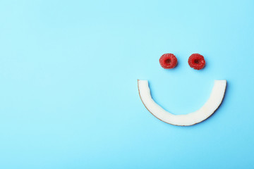 Funny flat lay composition with coconut and raspberry on color background. Space for text © New Africa