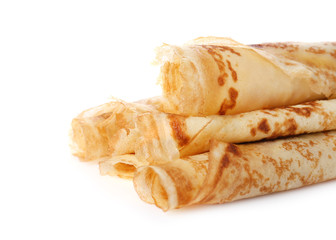 Tasty thin pancake rolls on white background