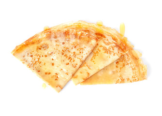 Tasty thin folded pancakes with honey on white background, top view