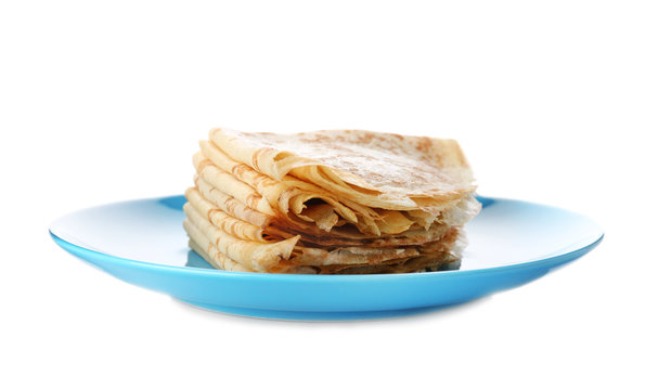 Stack of tasty thin folded pancakes on plate against white background