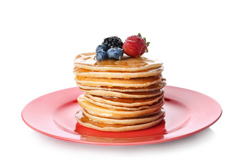 Plate with stack of tasty pancakes and fresh berries on white background