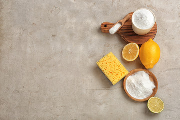 Flat lay composition with bowls of baking soda and space for text on gray table