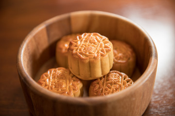 Traditional pastry mooncakes is offered to friends or family during Mid-Autumn Festival. Flatlay table top view dark light with copy space. The Chinese character represent 