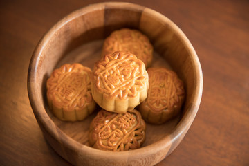 Traditional pastry mooncakes is offered to friends or family during Mid-Autumn Festival. Flatlay table top view dark light with copy space. The Chinese character represent 