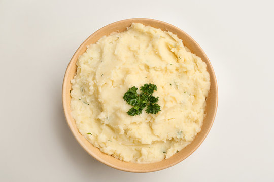 Bowl with tasty mashed potato on white background, top view