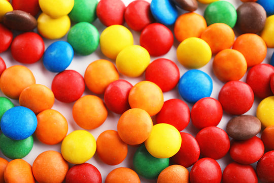 Many colorful candies as background, top view