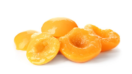 Halves of canned peaches on white background