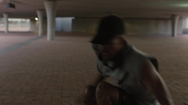 dancing man young mixed race breakdancer performing modern hip hop dance moves practicing urban freestyle choreography in city at sunset close up