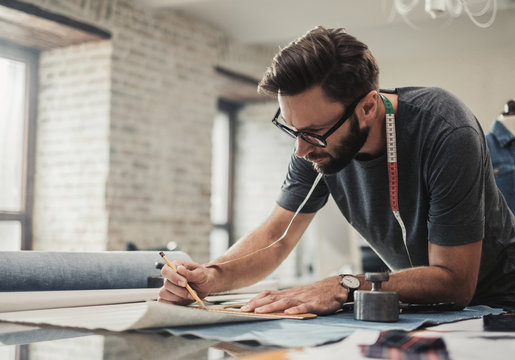 Fashion Designer Working In His Studio