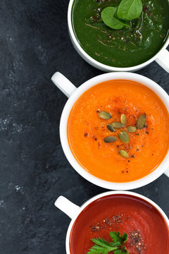assortment of fresh vegetable soup on a dark background, closeup, top view, vertical