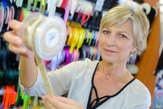 woman holding a roll of ribbon