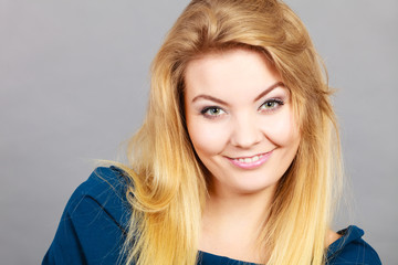 Portrait of happy blonde woman smiling with joy