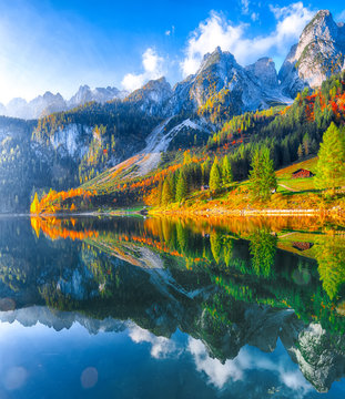Fototapeta autumn scenery with Dachstein mountain summit reflecting in crystal clear Gosausee mountain lake