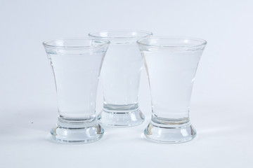 vodka in shot glasses on a white background