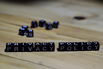 Privay policy message written on wooden blocks. education and motivation concepts. Cross processed...