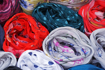 Fototapeta na wymiar Colors in Oia, colorful texture of scarves, Santorini, Cyclades, Greece