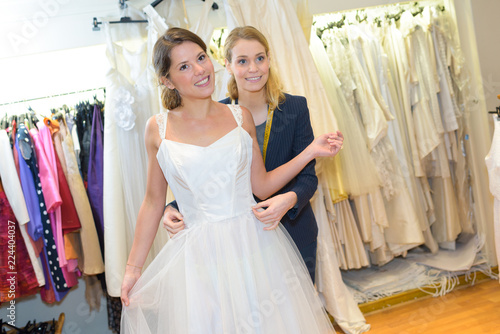 Female Trying On Wedding Dress With Dressmaker Stock Photo And