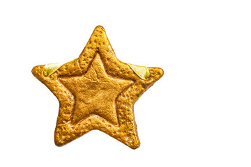 Decorative golden star handmade from dough isolated on a white background